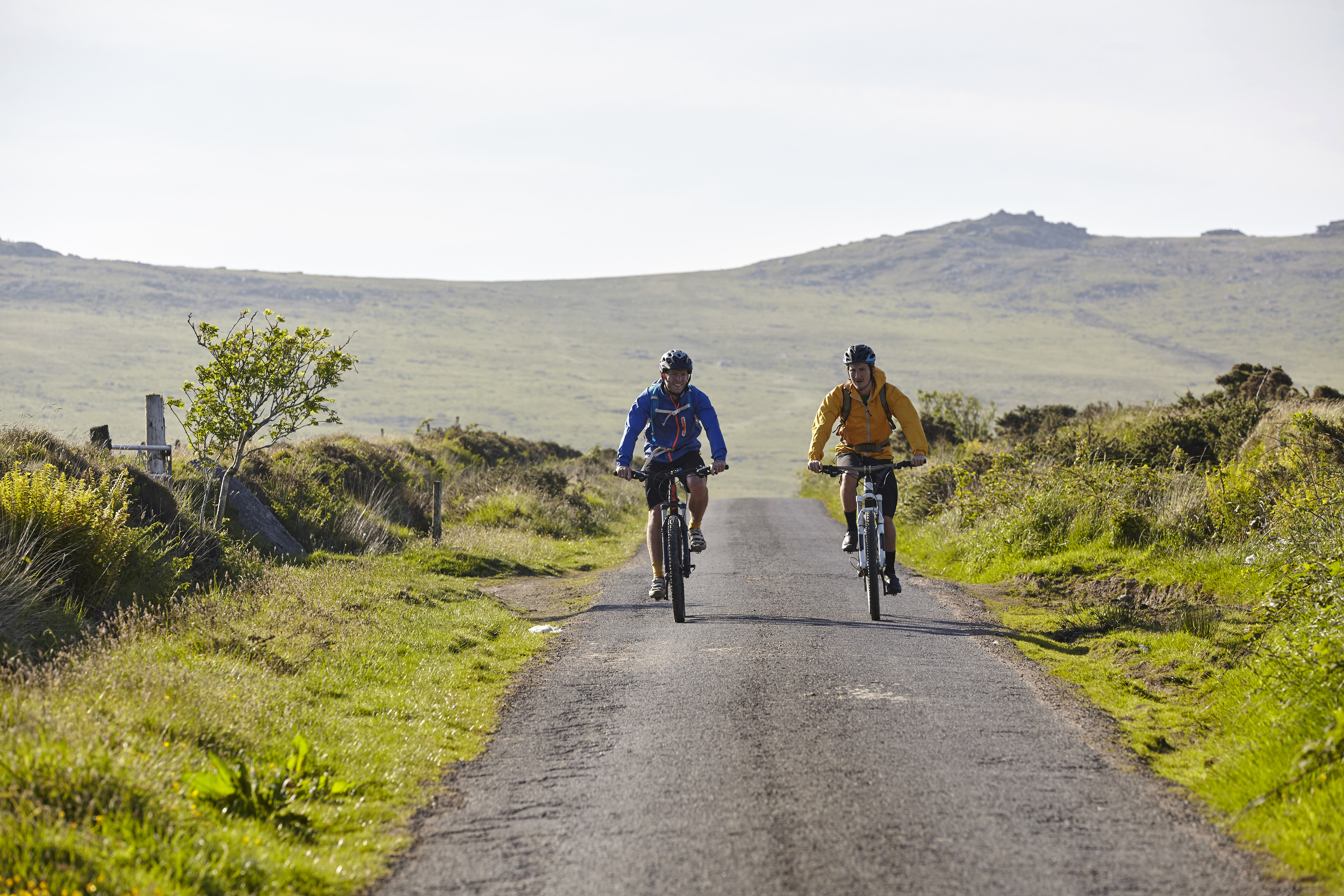 Two gravel cyclists riding together on an open road